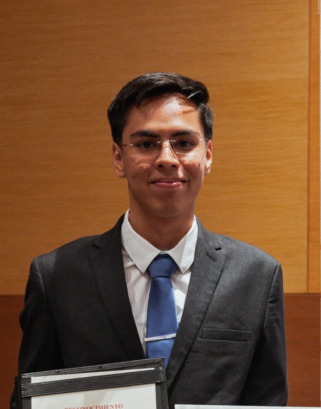 Picture of Hugo looking at the camera, smiling, dressed in a suit